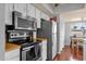 Galley kitchen featuring stainless steel appliances, light countertops, and wood floors at 6401 E Voltaire Ave, Scottsdale, AZ 85254