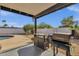Covered patio area complete with a BBQ grill and stylish outdoor kitchen setup for entertainment at 6401 E Voltaire Ave, Scottsdale, AZ 85254