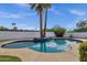 Inviting pool area with mature palm trees and crystal-clear water, perfect for relaxation and enjoyment at 6401 E Voltaire Ave, Scottsdale, AZ 85254