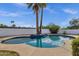 Backyard oasis featuring a refreshing pool, mature palm trees, blue tiled trim, and ample space for outdoor enjoyment at 6401 E Voltaire Ave, Scottsdale, AZ 85254