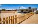 The oversized backyard features a gravel ground cover, a wooden fence, and a covered patio at 6501 W Columbus Ave, Phoenix, AZ 85033