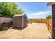 The backyard features dirt landscaping, a privacy fence, and a storage shed at 6501 W Columbus Ave, Phoenix, AZ 85033