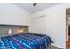 This cozy bedroom has a bed with colorful bedding, neutral walls, and plenty of natural light at 6501 W Columbus Ave, Phoenix, AZ 85033