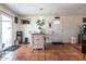 Dining area featuring terra cotta tile flooring, an island table and access to the home's backyard at 6501 W Columbus Ave, Phoenix, AZ 85033
