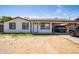Charming single-story home with a carport, featuring a clean white facade and freshly painted trim at 6501 W Columbus Ave, Phoenix, AZ 85033