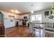 Bright kitchen featuring stainless steel appliances, white cabinetry, tile backsplash, terra cotta tile flooring and access to the yard at 6501 W Columbus Ave, Phoenix, AZ 85033