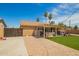 Aerial view of the backyard with artificial turf, pavers and covered patio at 6701 W Catalina Dr, Phoenix, AZ 85033