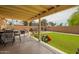 Spacious backyard with a covered patio, artificial turf, and plenty of space at 6701 W Catalina Dr, Phoenix, AZ 85033