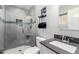 Updated bathroom featuring a glass-enclosed shower, modern fixtures, and a sleek vanity at 6701 W Catalina Dr, Phoenix, AZ 85033