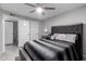 This bedroom boasts a black upholstered bed with a ceiling fan and two closets at 6701 W Catalina Dr, Phoenix, AZ 85033