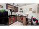 This kitchen has dark cabinetry, black countertops, and stainless steel microwave at 6701 W Catalina Dr, Phoenix, AZ 85033
