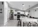 Well-lit kitchen showcasing a breakfast bar, ample storage, and modern finishes at 6701 W Catalina Dr, Phoenix, AZ 85033