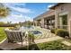 Resort-style backyard with pool, spa, covered patio, outdoor seating, and manicured lawn at 7327 E La Junta Rd, Scottsdale, AZ 85255