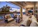 This backyard features a covered patio with lounge seating, dining area, and a view of the pool at 7327 E La Junta Rd, Scottsdale, AZ 85255