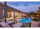 This backyard features a large pool, patio seating, an outdoor kitchen, and desert landscaping at 7327 E La Junta Rd, Scottsdale, AZ 85255