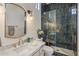 Luxurious bathroom with a marble vanity, gold fixtures, and glass-enclosed shower at 7327 E La Junta Rd, Scottsdale, AZ 85255