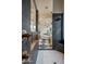 Elegant bathroom featuring a glass-enclosed shower, soaking tub, and stone accent wall at 7327 E La Junta Rd, Scottsdale, AZ 85255