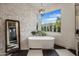 Bright bathroom with a soaking tub next to a large window and black and white tile floors at 7327 E La Junta Rd, Scottsdale, AZ 85255