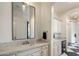 Well-lit bathroom featuring marble countertops, a vanity with ample storage, and a black framed mirror at 7327 E La Junta Rd, Scottsdale, AZ 85255