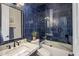 Bathroom showcasing blue tile, marble countertops, and a glass-enclosed shower at 7327 E La Junta Rd, Scottsdale, AZ 85255