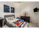 Cozy bedroom with gray bed, colorful blanket, and fun decor at 7327 E La Junta Rd, Scottsdale, AZ 85255