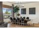 Elegant dining area featuring dark wood table, stylish chairs, and a large chandelier at 7327 E La Junta Rd, Scottsdale, AZ 85255