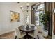 Cozy dining room with a round table, stylish chairs, and a large window overlooking the yard at 7327 E La Junta Rd, Scottsdale, AZ 85255