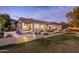 Gorgeous home exterior features a covered patio, outdoor seating, and lush greenery at 7327 E La Junta Rd, Scottsdale, AZ 85255