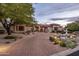 A landscaped front yard with a fountain, decorative lighting, a paver driveway, and desert plants at 7327 E La Junta Rd, Scottsdale, AZ 85255