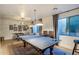 A game room with hardwood floors, decor, an area rug, and large windows for natural light at 7327 E La Junta Rd, Scottsdale, AZ 85255