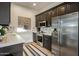 Contemporary kitchen with stainless steel appliances and dark cabinetry at 7327 E La Junta Rd, Scottsdale, AZ 85255