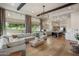 Open-concept living room and kitchen with hardwood floors and large windows with natural light at 7327 E La Junta Rd, Scottsdale, AZ 85255