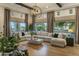 Spacious living area with hardwood floors, a sectional sofa, and large windows offering ample light at 7327 E La Junta Rd, Scottsdale, AZ 85255