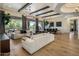 Expansive living area with hardwood floors, stylish decor, and multiple seating arrangements at 7327 E La Junta Rd, Scottsdale, AZ 85255
