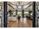 Spacious living area features wood floors, exposed beam ceiling, and elegant dining space at 7327 E La Junta Rd, Scottsdale, AZ 85255