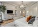 Bright main bedroom with chandelier, ensuite bathroom, and a sleek dresser at 7327 E La Junta Rd, Scottsdale, AZ 85255