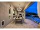 The covered patio includes an outdoor dining area, string lights, and views of the pool at 7327 E La Junta Rd, Scottsdale, AZ 85255