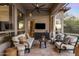 Inviting covered patio with TV, seating, and elegant decor at 7327 E La Junta Rd, Scottsdale, AZ 85255