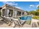 Upscale outdoor pool area featuring lounge seating and covered patio at 7327 E La Junta Rd, Scottsdale, AZ 85255