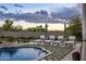 Charming outdoor space with luxury pool, lounge chairs and striped umbrellas at 7327 E La Junta Rd, Scottsdale, AZ 85255