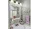 Bathroom with white framed mirror, leafy decor, and neutral wall color at 7750 E Broadway Rd # 774, Mesa, AZ 85208