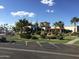 Beautifully landscaped clubhouse featuring putting green, lush greenery, and ample parking at 7750 E Broadway Rd # 774, Mesa, AZ 85208