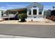 Charming manufactured home featuring a covered carport and landscaped front yard at 7750 E Broadway Rd # 774, Mesa, AZ 85208