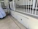 Manufactured home exterior showing under-deck storage and a white porch railing at 7750 E Broadway Rd # 774, Mesa, AZ 85208