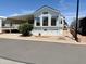 Attractive manufactured home with a covered carport, landscaped front yard, and well-maintained exterior at 7750 E Broadway Rd # 774, Mesa, AZ 85208