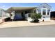 Charming mobile home showcasing ample covered parking and a well-maintained front yard at 7750 E Broadway Rd # 774, Mesa, AZ 85208