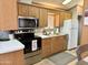 Functional kitchen with modern appliances and a light oak cabinets at 7750 E Broadway Rd # 774, Mesa, AZ 85208