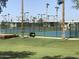 Well-maintained tennis court with green and blue playing surface, surrounded by lush landscaping at 7750 E Broadway Rd # 774, Mesa, AZ 85208