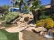 Serene water feature with rocky accents and vibrant flowers, adding tranquility to the community at 7750 E Broadway Rd # 774, Mesa, AZ 85208