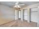 Bright bedroom featuring neutral walls, carpet, ceiling fan, and large closets at 8225 N Central Ave # 44, Phoenix, AZ 85020